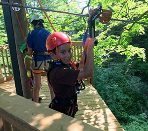 A boy getting ready to use the Wild Rouge zipline